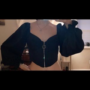 Black puff sleeve crop top with zipper up the front